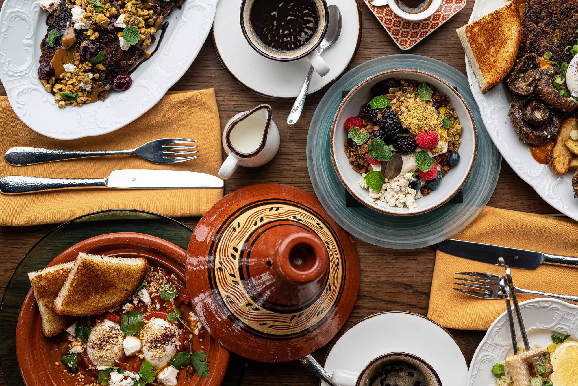 Flatlay of Darya brunch dishes on a wood top table