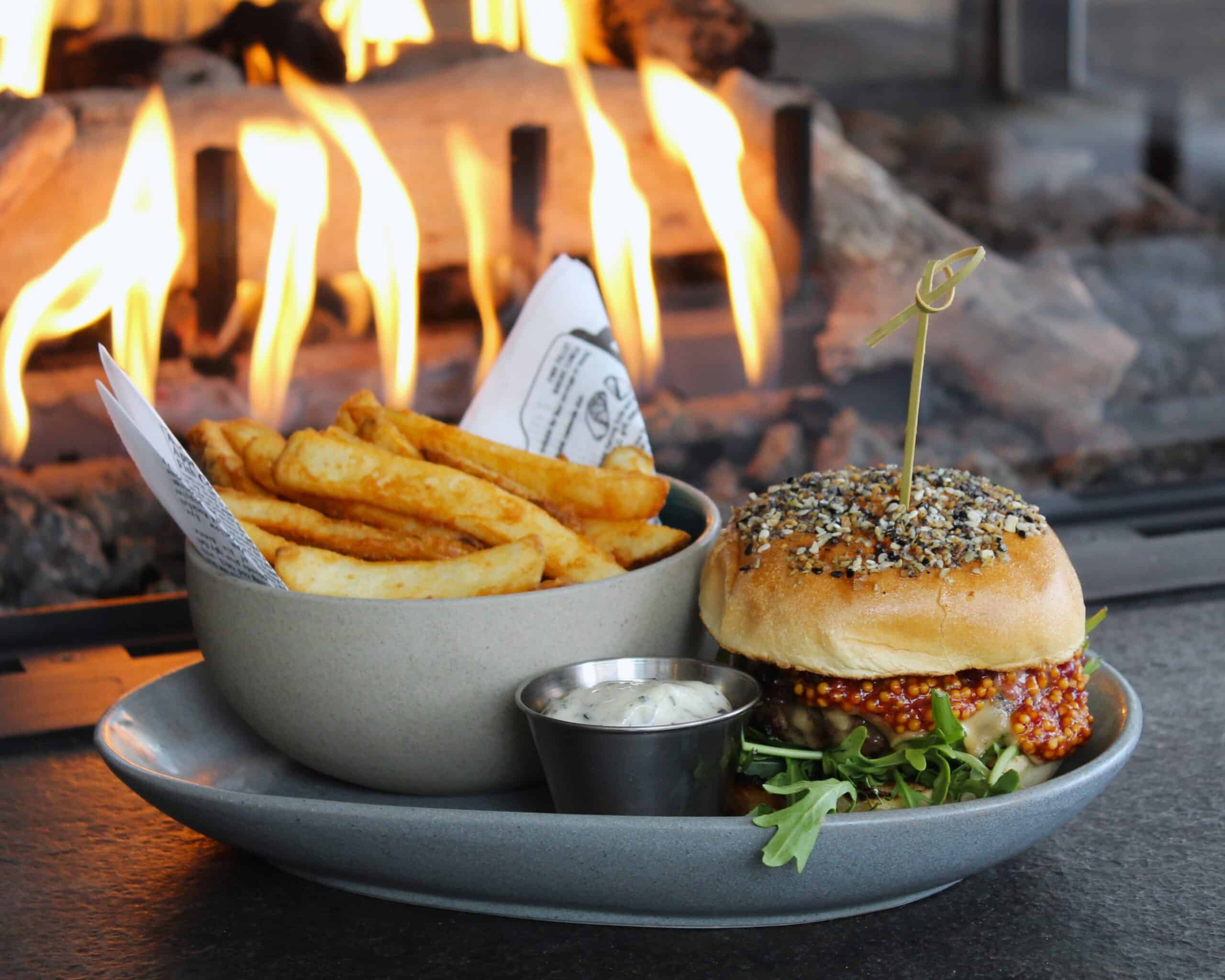 burger and fries next to the fireplace