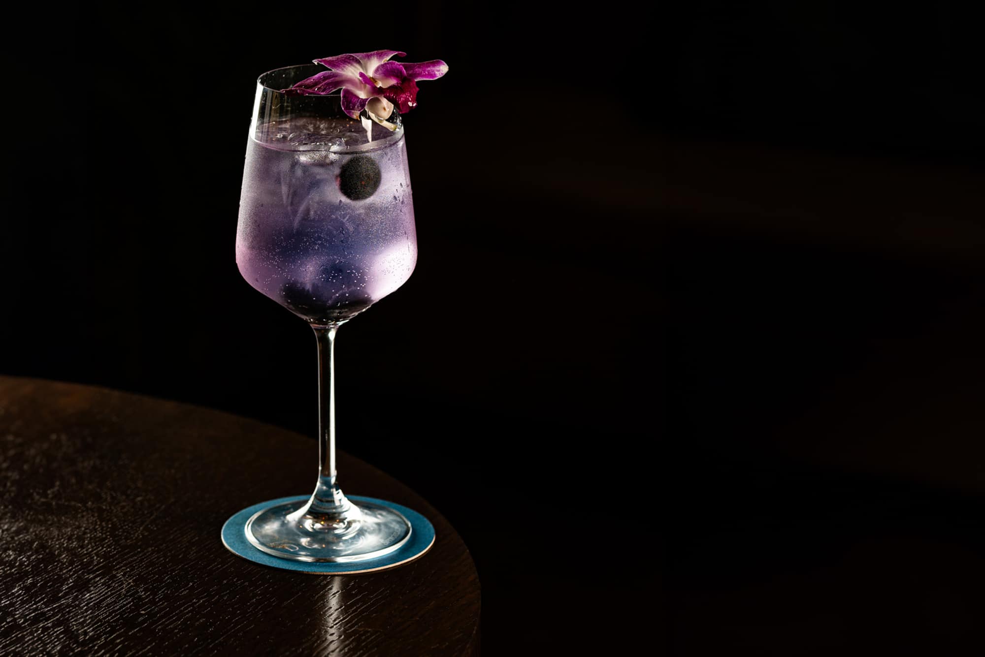 Purple cocktail against a dark background at Darya in Halifax