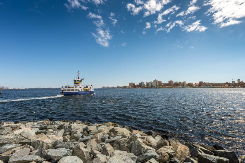 Ferry departing for Halifax from Dartmouth under deep blue sky w